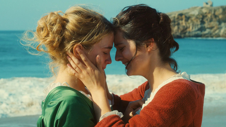 Adèle Haenel as Héloïse being embraced by Noémie Merlant as Marianne by the ocean in Portrait of a Lady on Fire (2019)