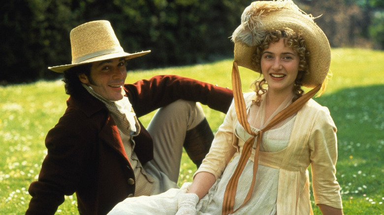 Greg Wise and Kate Winslet as John and Marianne sitting in a field in Sense and Sensibility (1995)