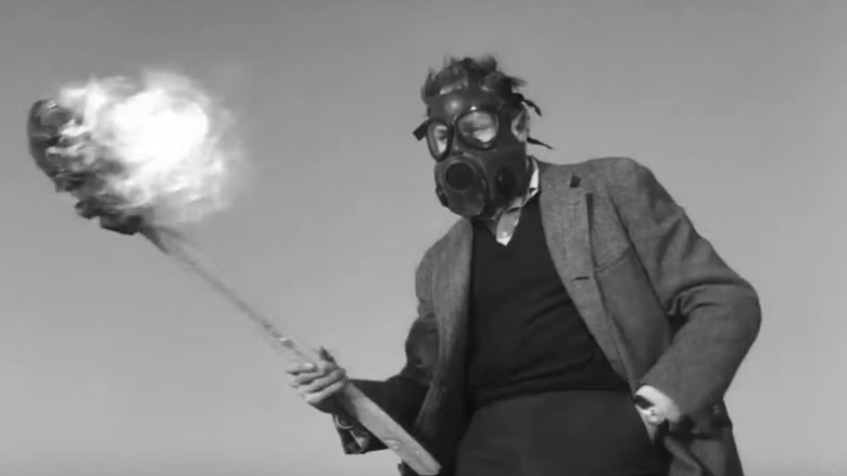 Dr. Robert Morgan holding a torch while wearing a gas mask in "The Last Man on Earth"