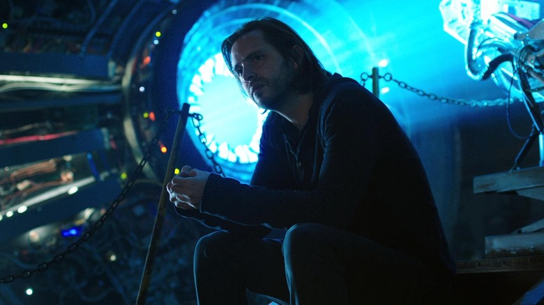 James sitting in front of a portal in 12 Monkeys (2015)