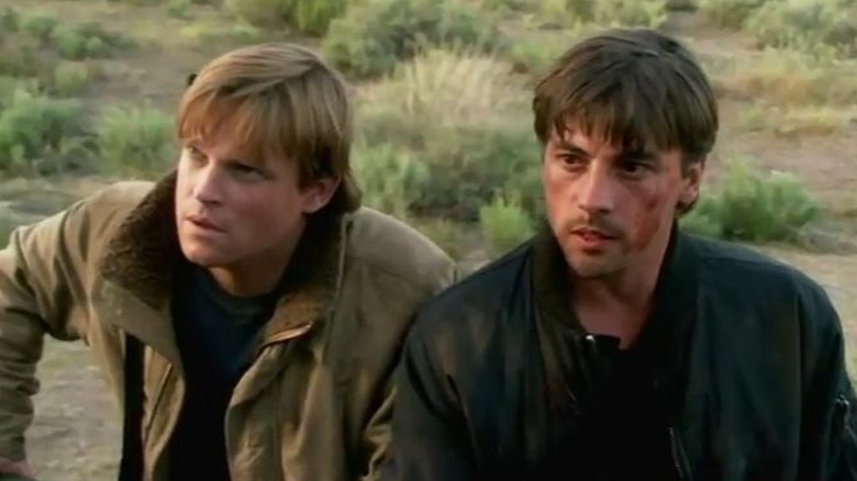 Stanley and Jake sitting together in a field in Jericho (2006)