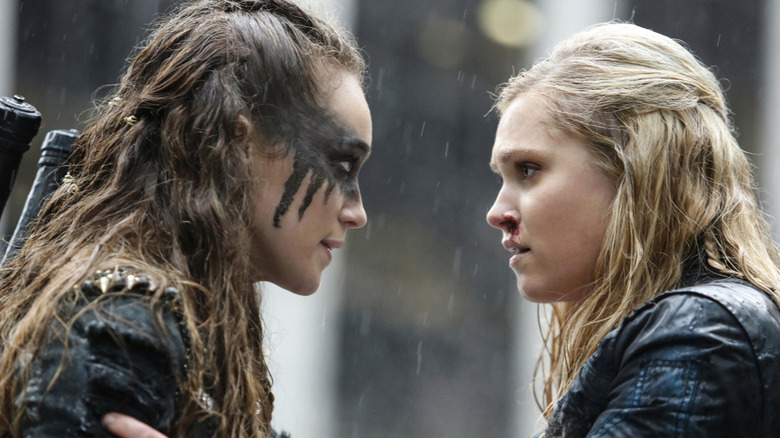 Clarke and Lexa look at one another in the rain in The 100 (2014)