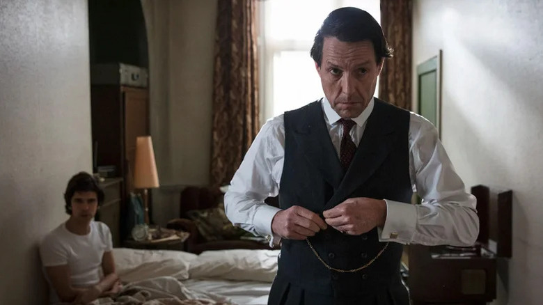 Jeremy Thorpe buttoning his vest on A Very English Scandal