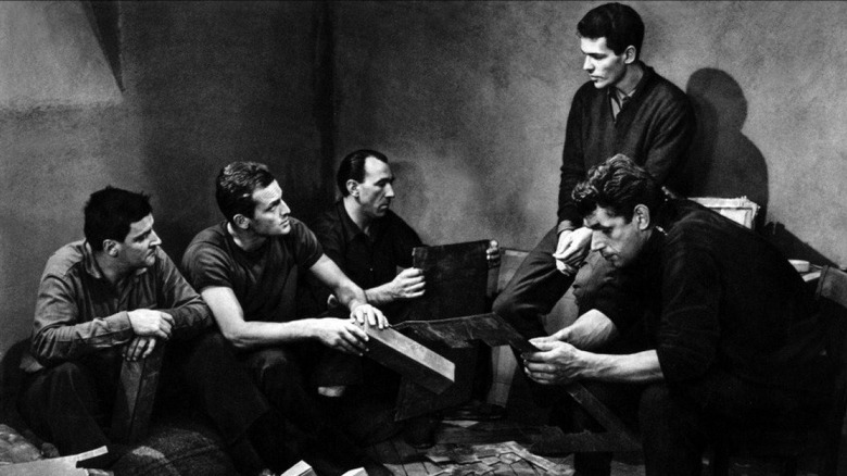 A group of prisoners converse in a cell in 'Le Trou' (The Hole) (1960)