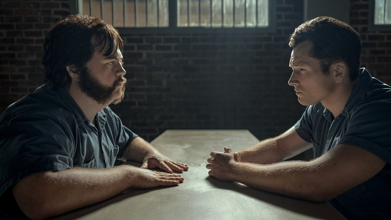 Larry Hall and Jimmy Keene staring each other down across the table in "Black Bird"