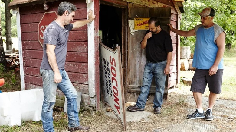 Mark Wolfe and Frank Fritz negotiating over an old sign