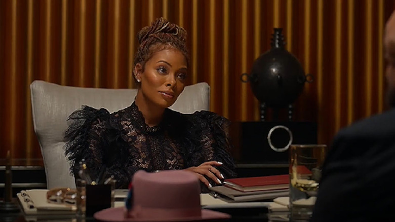 Marilyn Deville gives a smug glance at her desk in "All the Queen's Men"