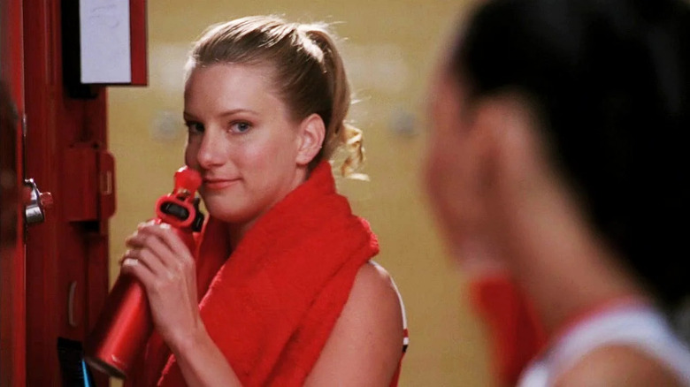 Brittany Pierce holds a water bottle to her lips and gives a smirk to Santana Lopez in "Glee"