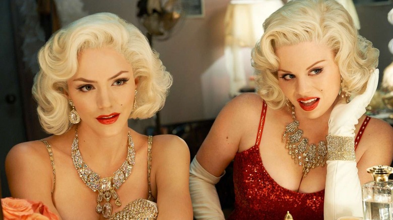 Karen Cartwright looks into a mirror next to a costar in "Smash"