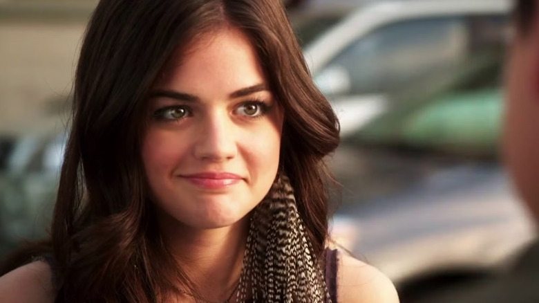 Aria Montgomery gives a crooked smile to someone off camera in "Pretty Little Liars"