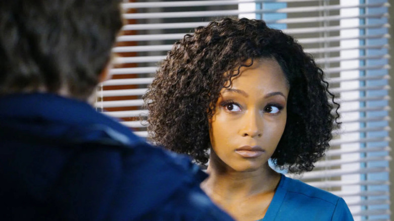 April Sexton stares quizzically at a person off-screen in "Chicago Med"