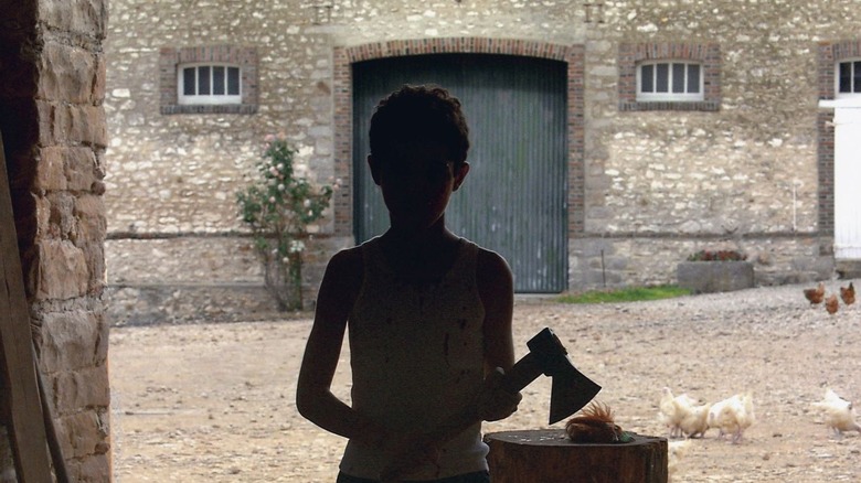 Young Majid's silhouette holding an axe in the movie Caché