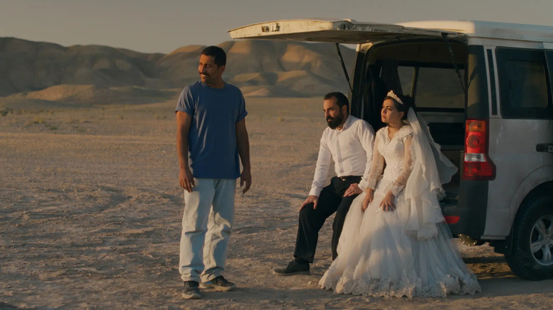 Hamid, Goli and Ali sitting at the back of an open van in the desert in the movie It Was Just An Accident