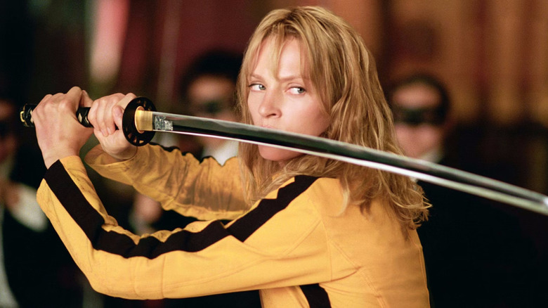 The Bride in a yellow suit holding a long sword in the movie Kill Bill