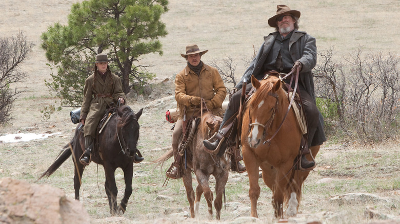 Mattie Ross, LaBoeuf and Rooster Cogburn on horseback in a Western landscape in True Grit (2010)