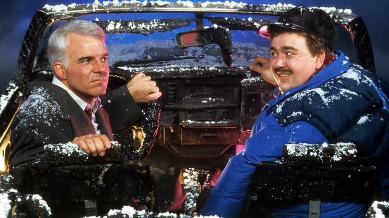 Neal Page glares as Del Griffith smiles in Planes, Trains and Automobiles