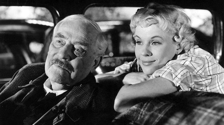Professor Isak Borg sits with Sara in a car in Wild Strawberries