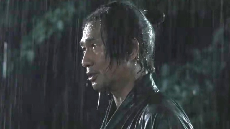 Kanichiro Yoshimura looking serious in the rain in When The Last Sword Is Drawn