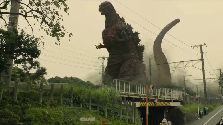 Godzilla towers over a bridge in rural Japan in "Shin Godzilla" (2016)