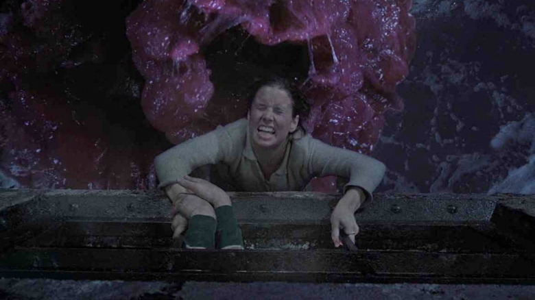 Meg dangles precariously over the gaping maw of the pink Blob in "The Blob" (1988)