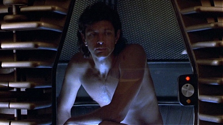 Seth Brundle crouching in teleportation machine in "The Fly" (1986)
