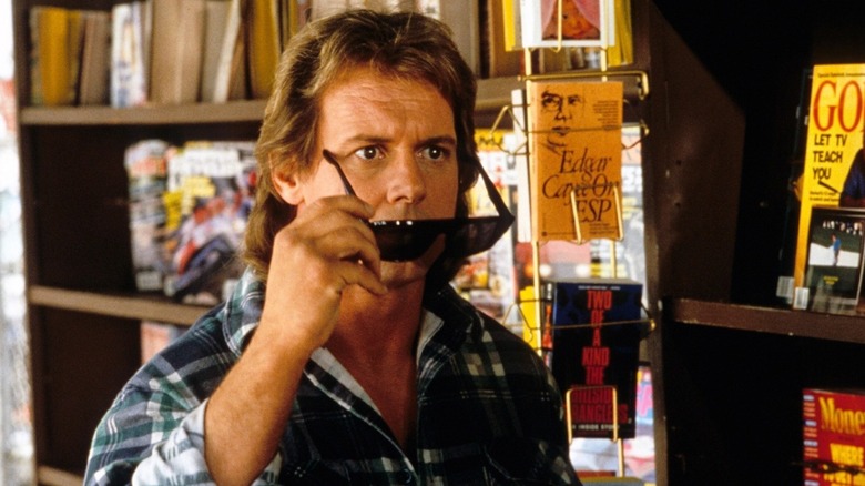 Nada removes his sunglasses in "They Live" (1988)