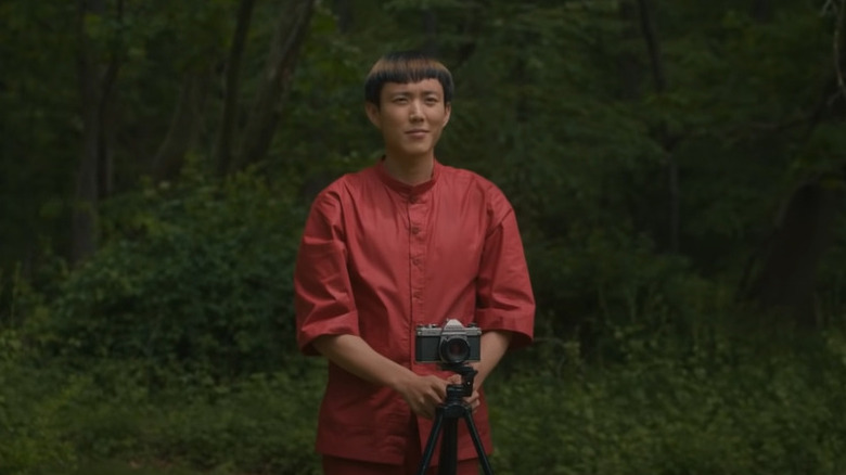Yang taking photo in woods