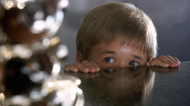 David peeking above a table in 'AI: Artificial Intelligence' (2001)