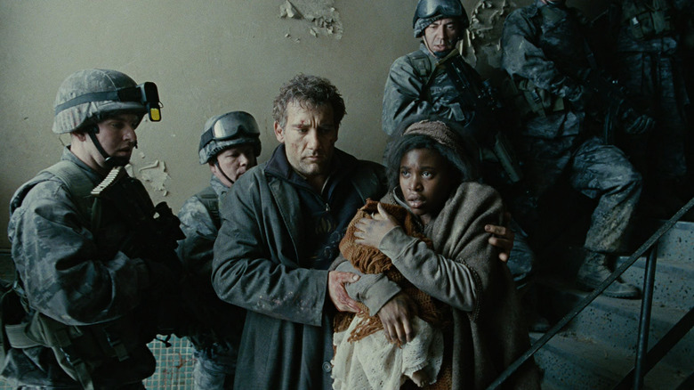 Theo escorts Kee past police in 'Children of Men' (2006)