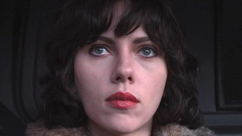 A woman in red lipstick sits in 'Under the Skin' (2013)