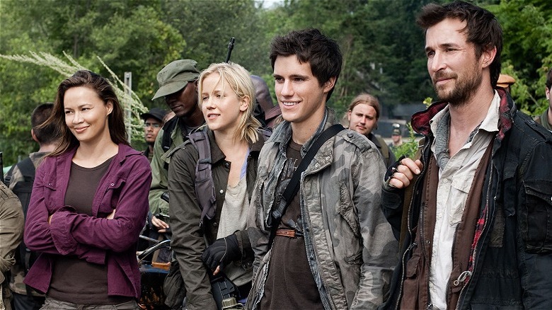 Anne, Karen, Hal, and Tom standing together and smiling in "Falling Skies."