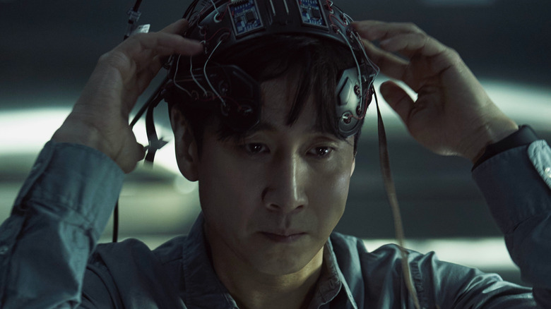 Sewon adjusting a headset in Dr. Brain (2021)