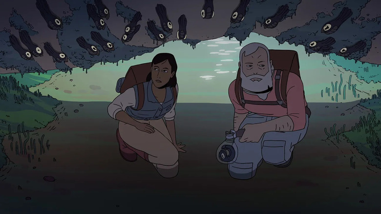 Urusla and Sam kneel down to look under a rock where a dozen black, big eyed bugs look up at them in "Scavengers Reign"