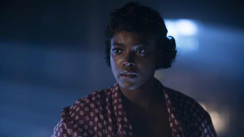 Ruby Baptiste standing outside at night in "Lovecraft Country"