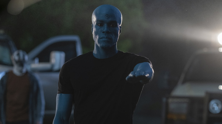 Doctor Manhattan holding out his arm in "Watchmen"
