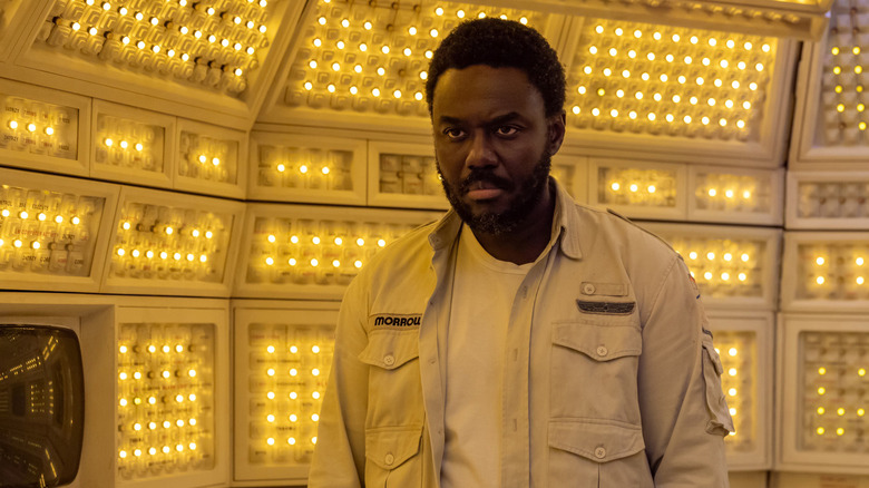 Cyborg security office Morrow standing in the secured, brightly lit cockpit of the Maginot