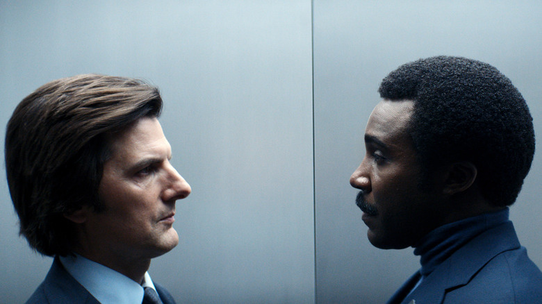 Mark and his manager, Milchick (Tramell Tillman), staring each other down in a Lumon elevator