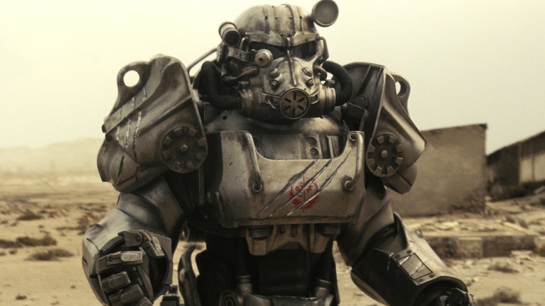 A suit of Brotherhood of Steel power armor standing in the wasteland in Fallout (2024)
