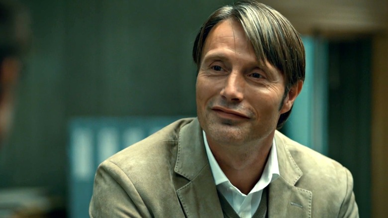 Lecter smiling at someone off camera in "Hannibal"