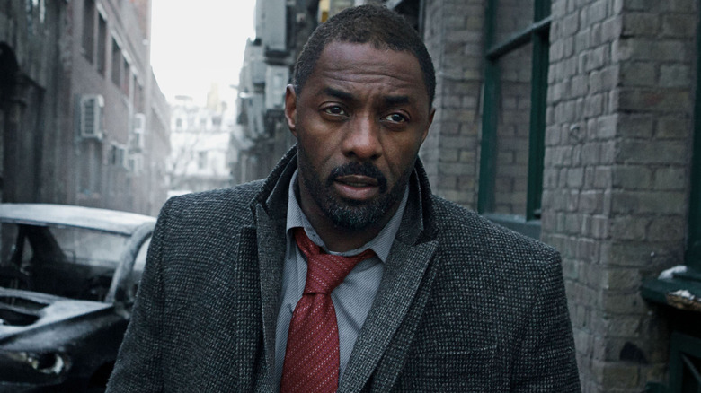 Luther looking serious walking in the street