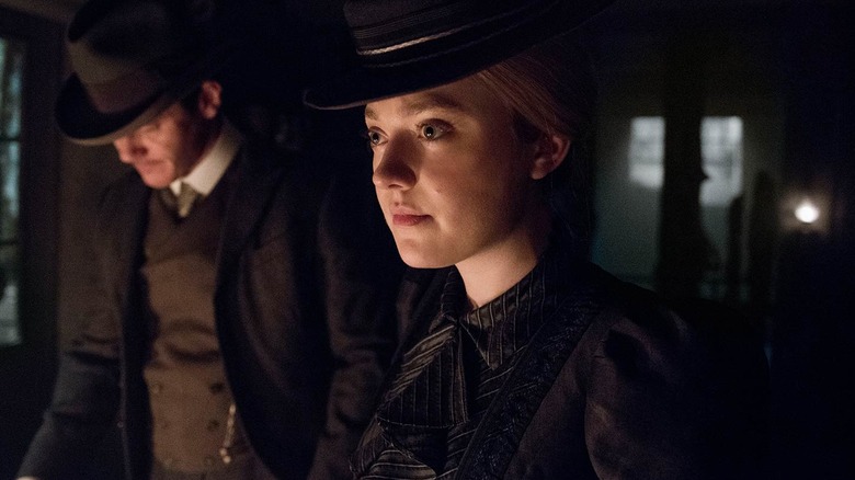 Sara and John in a dimly lit room in "The Alienist"
