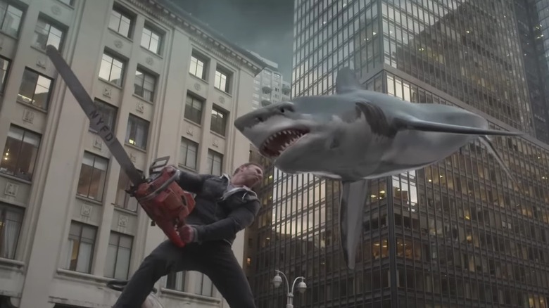 Fin braces with his chainsaw for a shark flying at his head