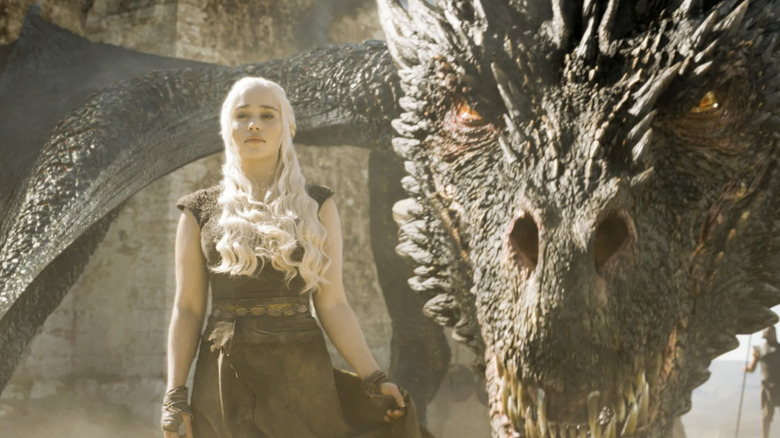 Daenerys standing next to Drogon on "Game of Thrones" (2011-2019)