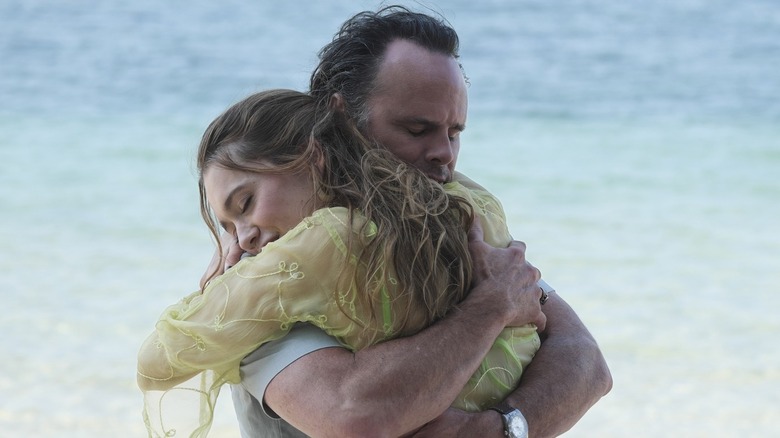 Chelsea and Rick embrace on the beach on "The White Lotus" (2021-2025)