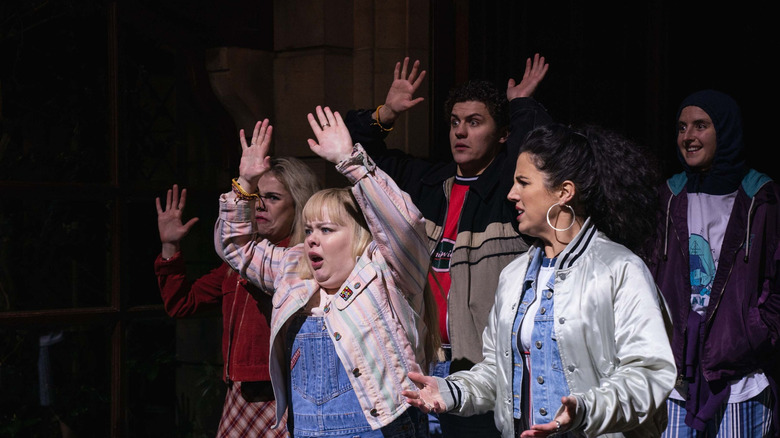The Derry Girls with their hands raised in "Derry Girls"