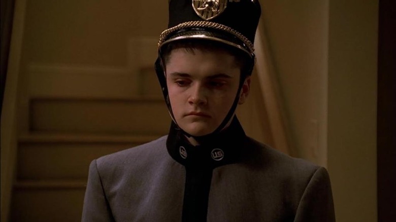 A.J. wears uniform in living room