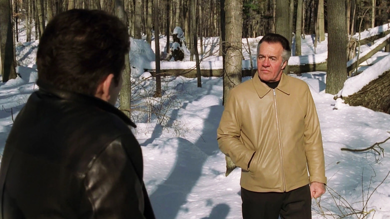 Christopher and Paulie stand in snowy woods