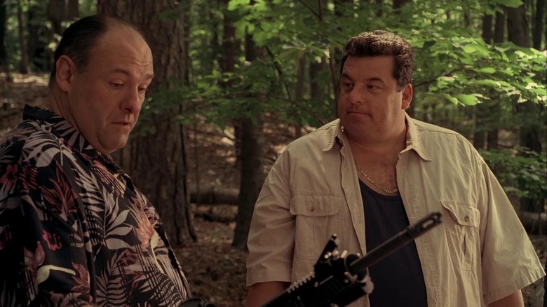 Tony and Bobby hold guns in the woods