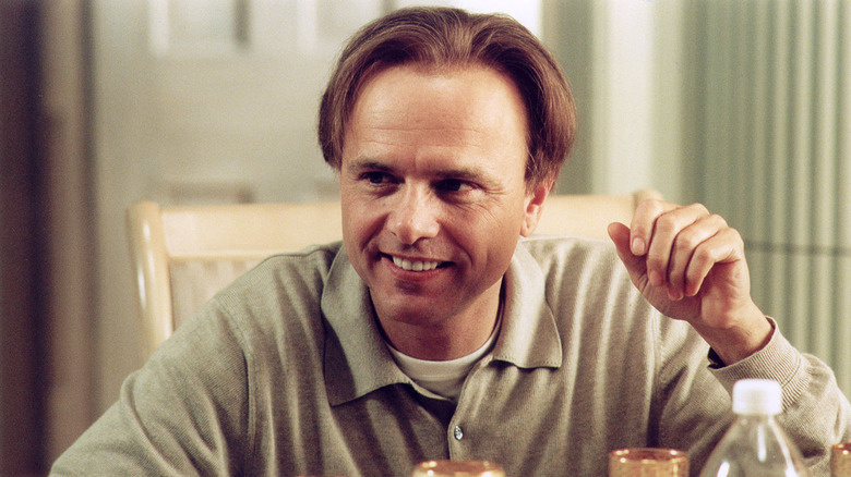 Ralph laughs at dinner table