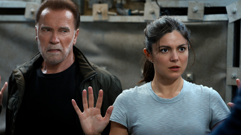 Luke and Emily Brunner looking at a man in FUBAR